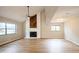 Bright living room with vaulted ceiling, fireplace, new flooring, and abundant natural light at 14909 Oldgate Pl, Tampa, FL 33624