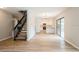 Bright living room with open staircase leading into the well-lit kitchen with modern finishes at 14909 Oldgate Pl, Tampa, FL 33624