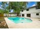 Backyard pool with a patio area and view of the white, two-story home at 14909 Oldgate Pl, Tampa, FL 33624