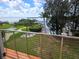 A view from the deck of a waterfront property featuring a pool, dock, fire pit, and beautiful scenery at 1626 Sea Breeze Dr, Tarpon Springs, FL 34689