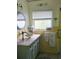A quaint bathroom offers charming, vintage style and decorative accents at 1626 Sea Breeze Dr, Tarpon Springs, FL 34689