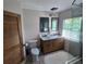 Bright bathroom features double sinks, wood cabinets and modern fixtures at 1626 Sea Breeze Dr, Tarpon Springs, FL 34689