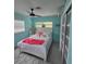 Light and airy bedroom with light blue walls, ceiling fan, and white bedroom set at 1626 Sea Breeze Dr, Tarpon Springs, FL 34689