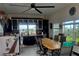 Stylish dining room features dark wood cabinets, a large table, and a modern ceiling fan at 1626 Sea Breeze Dr, Tarpon Springs, FL 34689