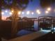 Picturesque waterfront view from the dock with string lights and a tranquil sunset reflecting on the calm water at 1626 Sea Breeze Dr, Tarpon Springs, FL 34689