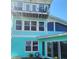 Close-up of the home's tower, lots of glass, and the backyard featuring a manicured lawn at 1626 Sea Breeze Dr, Tarpon Springs, FL 34689