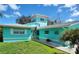 Beautiful turquoise single-Gathering home with a well-kept lawn and an inviting front entrance at 1626 Sea Breeze Dr, Tarpon Springs, FL 34689