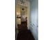 Hallway leading to back door has blue custom cabinets and dark wood-look tile flooring at 1626 Sea Breeze Dr, Tarpon Springs, FL 34689