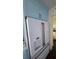 Kitchen featuring custom blue cabinets with modern hardware and stainless steel refrigerator at 1626 Sea Breeze Dr, Tarpon Springs, FL 34689