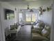 Cozy living room featuring comfortable seating, stylish decor, and a large window overlooking the outdoors at 1626 Sea Breeze Dr, Tarpon Springs, FL 34689