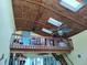 Unique loft area featuring a wood ceiling, skylights, and ceiling fans at 1626 Sea Breeze Dr, Tarpon Springs, FL 34689