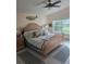 Sun-filled main bedroom featuring wood floors, a ceiling fan, and large windows at 1626 Sea Breeze Dr, Tarpon Springs, FL 34689
