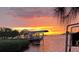 Dockside location with stunning sunset views, lush greenery, and a charming covered boat lift at 1626 Sea Breeze Dr, Tarpon Springs, FL 34689