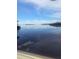 Serene waterfront view showcasing the calm water and distant shoreline at 1626 Sea Breeze Dr, Tarpon Springs, FL 34689