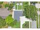 An aerial view of a home with a well-manicured lawn and a long, paved driveway at 1707 Solon Ave, Dunedin, FL 34698