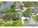 Aerial view of a home near a lake, showcasing its landscaping and proximity to nearby amenities at 1707 Solon Ave, Dunedin, FL 34698