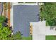 An aerial view of a home with a newly installed roof, driveway, and landscaping at 1707 Solon Ave, Dunedin, FL 34698