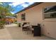 Outdoor dining on the back patio featuring a small seating area and grill station surrounded by a wood fence at 1707 Solon Ave, Dunedin, FL 34698