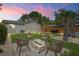Beautiful backyard featuring a cozy fire pit area and lush landscaping with ample seating for entertaining at 1707 Solon Ave, Dunedin, FL 34698