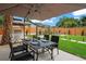 Backyard patio featuring outdoor dining under an umbrella and grill area at 1707 Solon Ave, Dunedin, FL 34698
