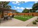 Backyard featuring a dining table, grill, swing set, stepping stones and a seating area at 1707 Solon Ave, Dunedin, FL 34698
