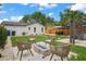 Beautiful backyard featuring a cozy fire pit area and lush landscaping with ample seating for entertaining at 1707 Solon Ave, Dunedin, FL 34698
