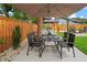 Outdoor dining set with grill area for entertaining in a fenced in backyard at 1707 Solon Ave, Dunedin, FL 34698