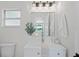 Chic bathroom featuring a modern vanity, mirror, and a large window providing natural light at 1707 Solon Ave, Dunedin, FL 34698