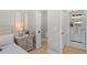 Bedroom featuring a walk-in closet, bedside table, and open door to a well-lit bathroom at 1707 Solon Ave, Dunedin, FL 34698