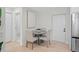 Dining area boasts a round table with upholstered chairs, alongside a well-lit, modern design at 1707 Solon Ave, Dunedin, FL 34698