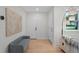 Bright entryway with hardwood floors, modern decor, and a bench for comfortable seating at 1707 Solon Ave, Dunedin, FL 34698