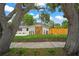 Home exterior featuring stone accents and mature trees with landscaping at 1707 Solon Ave, Dunedin, FL 34698