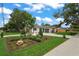 Charming home featuring a manicured lawn and rock details at 1707 Solon Ave, Dunedin, FL 34698