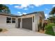 View of the home's exterior, showing the garage entrance and front door at 1707 Solon Ave, Dunedin, FL 34698