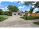 Charming home with a manicured lawn, stone accents and a newly sealed driveway at 1707 Solon Ave, Dunedin, FL 34698