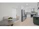 Open concept kitchen and dining area with stainless steel appliances and modern finishes at 1707 Solon Ave, Dunedin, FL 34698
