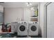 Bright laundry room area with a washer, dryer and water heater at 1707 Solon Ave, Dunedin, FL 34698