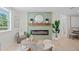 Cozy living room featuring a modern fireplace with mantel, complemented by a comfortable chair and throw pillows at 1707 Solon Ave, Dunedin, FL 34698
