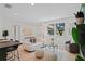 Bright, open living area with a view of the garage through a large window and stylish furniture at 1707 Solon Ave, Dunedin, FL 34698