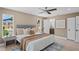 Relaxing main bedroom features a ceiling fan, plush pillows, a bathroom and a walk in closet at 1707 Solon Ave, Dunedin, FL 34698