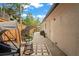 Back patio featuring egg chair and a cozy outdoor dining set with view of backyard at 1707 Solon Ave, Dunedin, FL 34698
