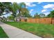 A lush green front yard with a view of a wood fence at 1707 Solon Ave, Dunedin, FL 34698