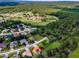 A scenic aerial view of a residential area with golf course, pond, and lush greenery at 18168 Clearview Dr, Brooksville, FL 34604