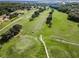 Aerial perspective of a golf course with verdant fairways, mature trees, and neatly arranged residential houses at 18168 Clearview Dr, Brooksville, FL 34604