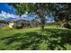 Large backyard featuring a screened-in patio and pool area, ideal for relaxation and leisure at 18168 Clearview Dr, Brooksville, FL 34604