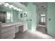 Bright bathroom featuring a large mirror, white vanity and access to the bedroom at 18168 Clearview Dr, Brooksville, FL 34604