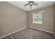 Neutral bedroom offering plush carpeting and a bright window overlooking the exterior at 18168 Clearview Dr, Brooksville, FL 34604