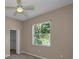 Bedroom featuring a ceiling fan, carpet floors, and natural light from a window at 18168 Clearview Dr, Brooksville, FL 34604