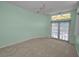 Large bedroom featuring a ceiling fan and light walls with pool access at 18168 Clearview Dr, Brooksville, FL 34604