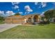 Well-maintained home featuring a manicured lawn, mature trees, and attractive landscaping in the front yard at 18168 Clearview Dr, Brooksville, FL 34604